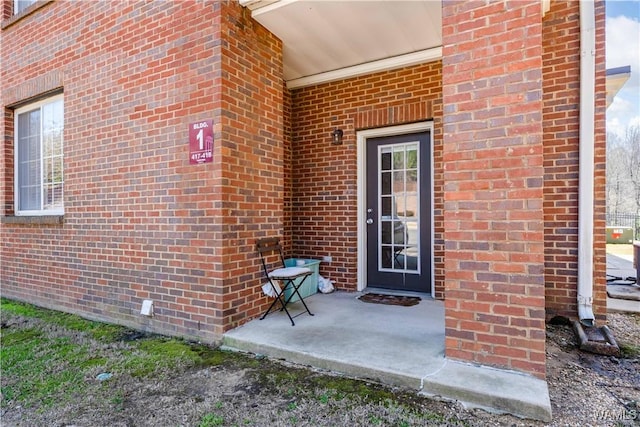 property entrance with brick siding