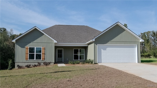 view of front of property featuring a front lawn and a garage