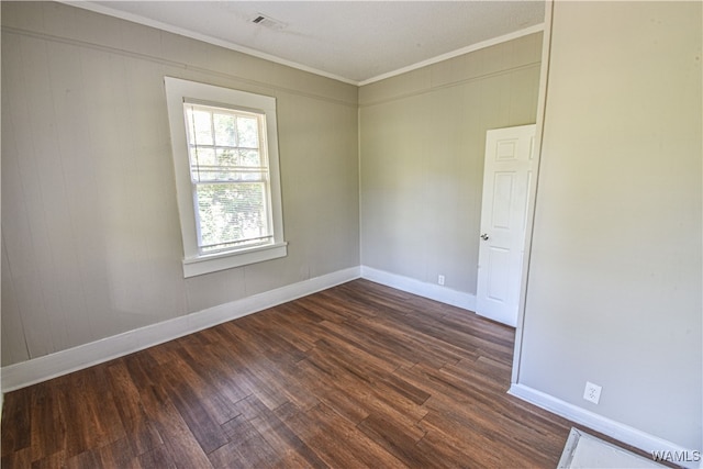 unfurnished room with dark hardwood / wood-style floors and ornamental molding