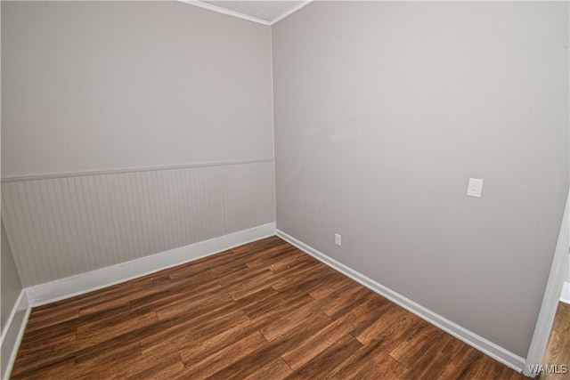 unfurnished room with dark hardwood / wood-style floors and ornamental molding