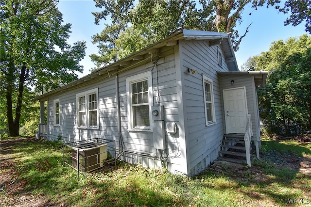 view of side of home with cooling unit