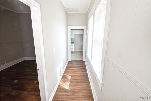 hall featuring crown molding and dark hardwood / wood-style floors