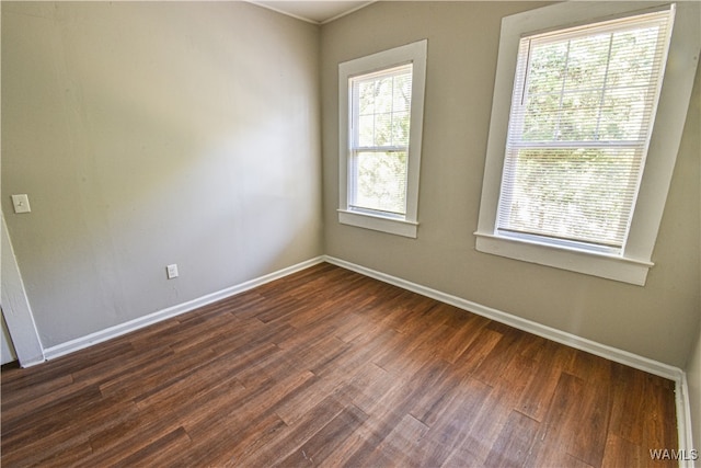 unfurnished room with dark hardwood / wood-style flooring