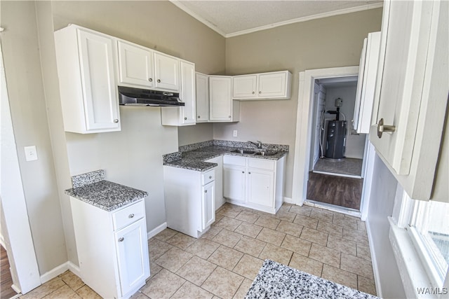 kitchen featuring white cabinets, crown molding, sink, a textured ceiling, and water heater