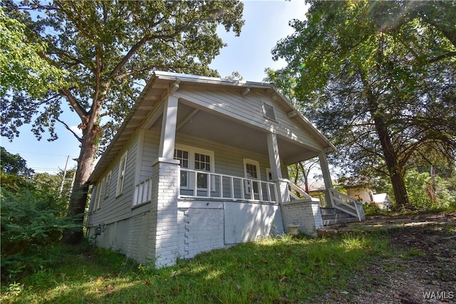 view of property exterior with a porch