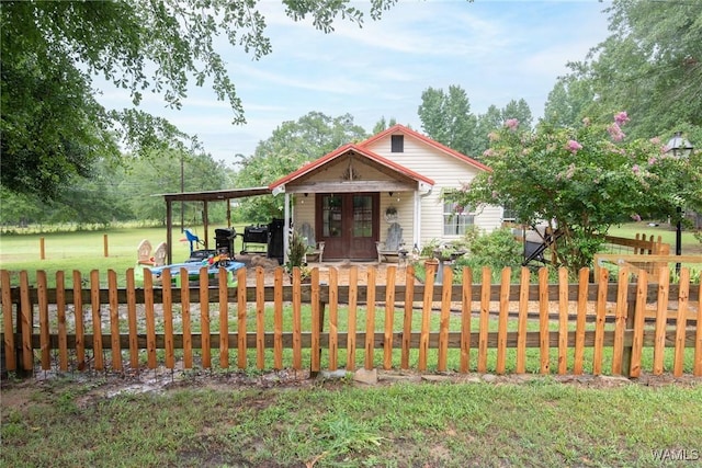 bungalow-style home featuring a front yard and fence