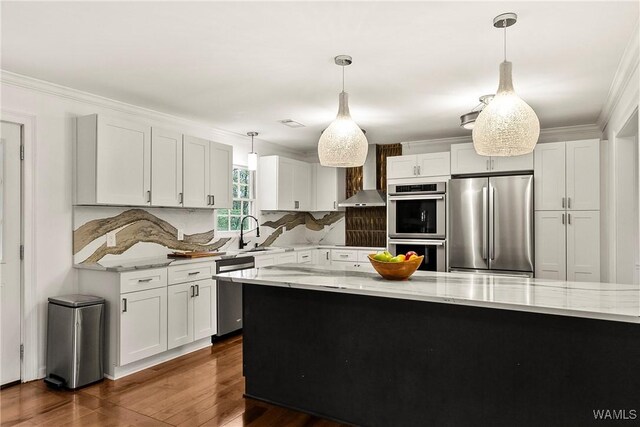 600 Innsbruck Ct, Northport, AL 35473 - kitchen featuring stainless steel appliances, wall chimney range hood, crown molding, light stone countertops, and white cabinetry