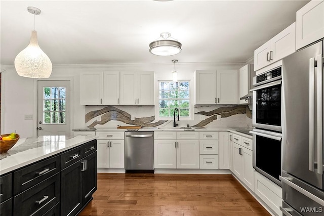 600 Innsbruck Ct, Northport, AL 35473 - kitchen with stainless steel appliances, dark cabinetry, plenty of natural light, and white cabinets