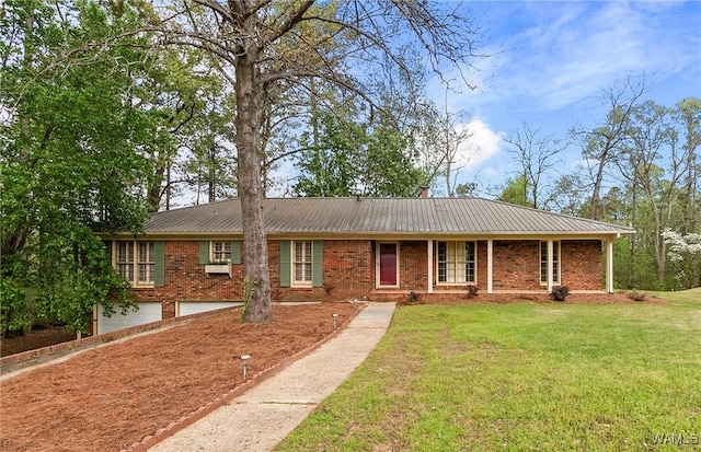 600 Innsbruck Ct, Northport, AL 35473 - single story home featuring an attached garage, a front lawn, brick siding, and a metal roof