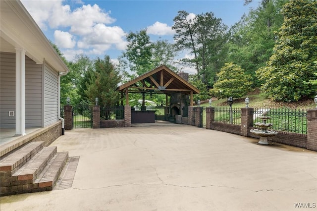 view of patio / terrace with a gazebo and exterior fireplace