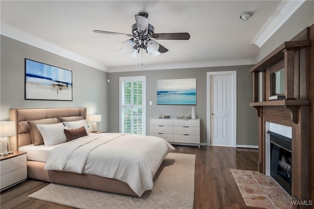 bedroom featuring a fireplace with flush hearth, crown molding, ceiling fan, and wood finished floors