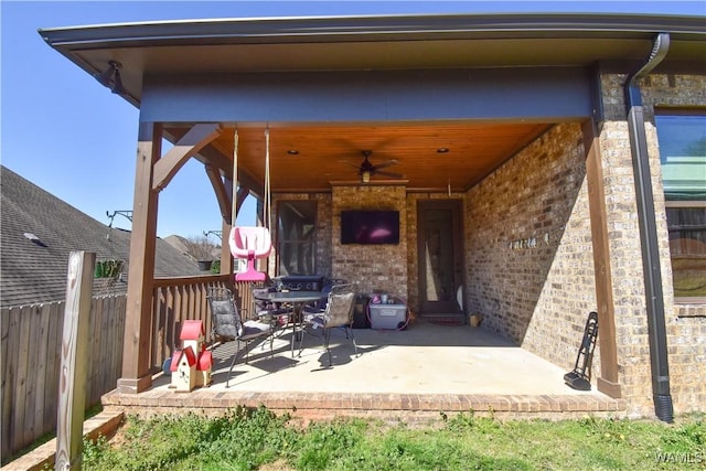 view of patio with ceiling fan and fence