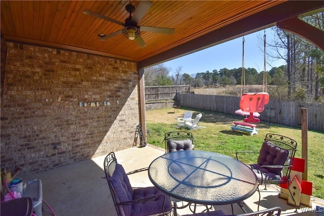 view of patio / terrace featuring outdoor dining space, a fenced backyard, and a ceiling fan