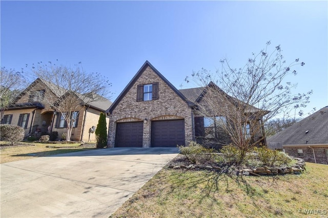 view of front of house with a garage, concrete driveway, and brick siding