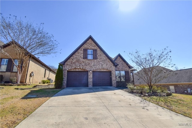 view of front facade featuring a garage, concrete driveway, brick siding, and a front lawn