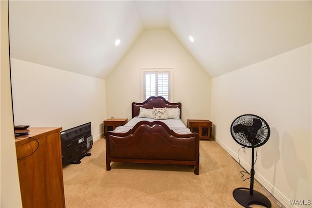 bedroom with vaulted ceiling, light carpet, and baseboards