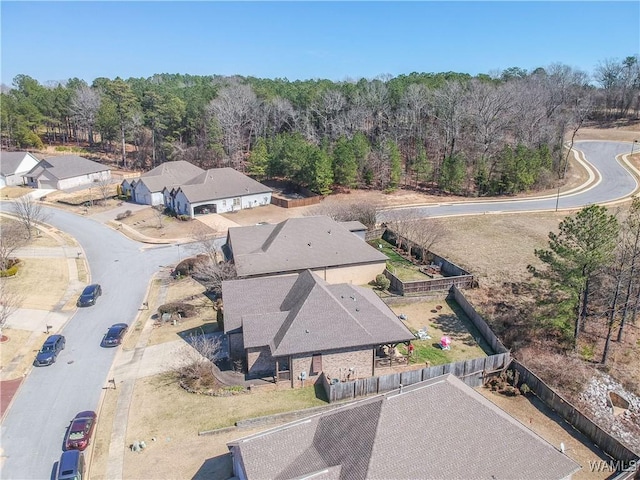 drone / aerial view with a wooded view