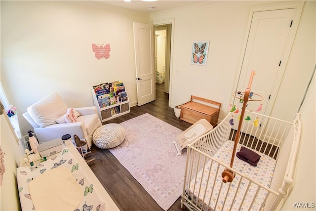 bedroom featuring baseboards and wood finished floors