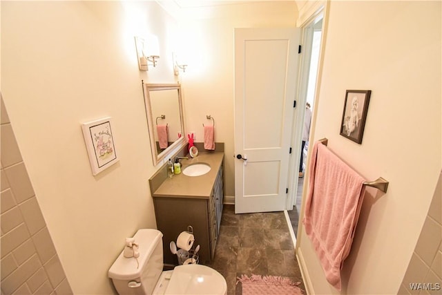 bathroom featuring toilet and vanity