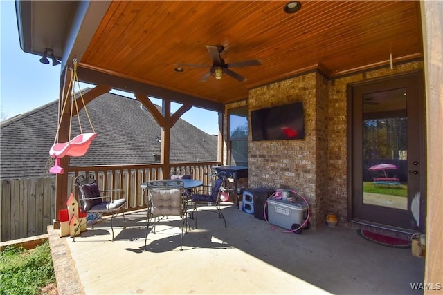 view of patio / terrace with fence, a ceiling fan, and outdoor dining space