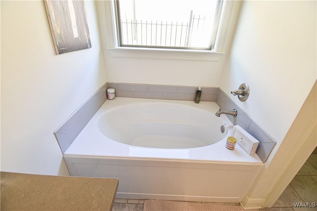 full bathroom featuring a bath and tile patterned floors