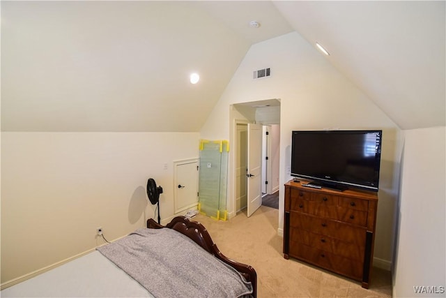 bedroom featuring visible vents, vaulted ceiling, and light colored carpet