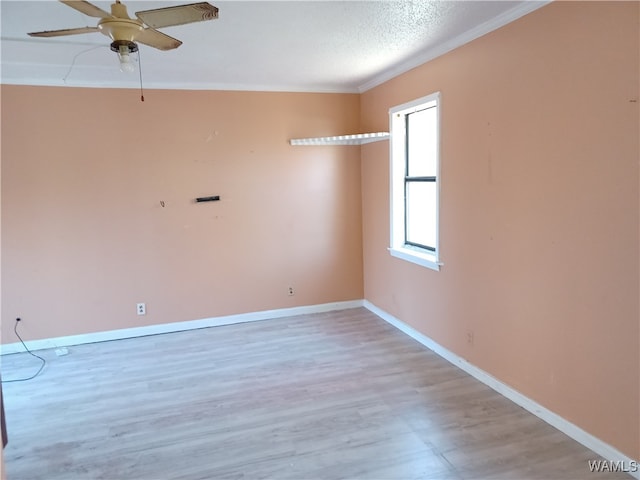 spare room featuring ceiling fan, ornamental molding, a textured ceiling, and hardwood / wood-style flooring