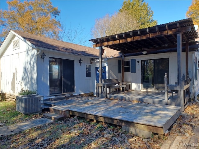 rear view of property with a wooden deck and central AC