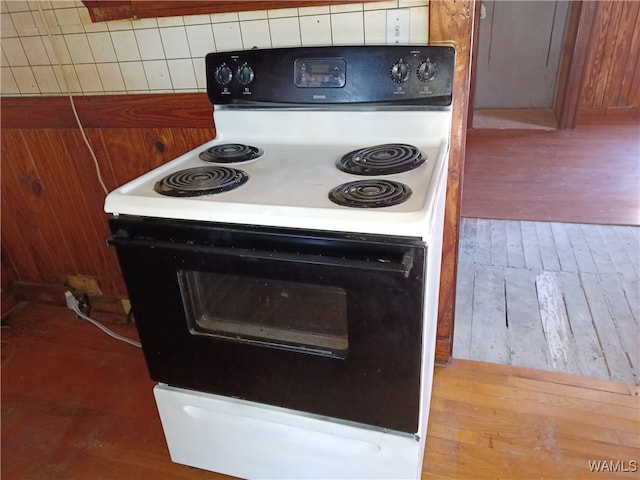 kitchen featuring decorative backsplash, light hardwood / wood-style floors, and white range with electric stovetop