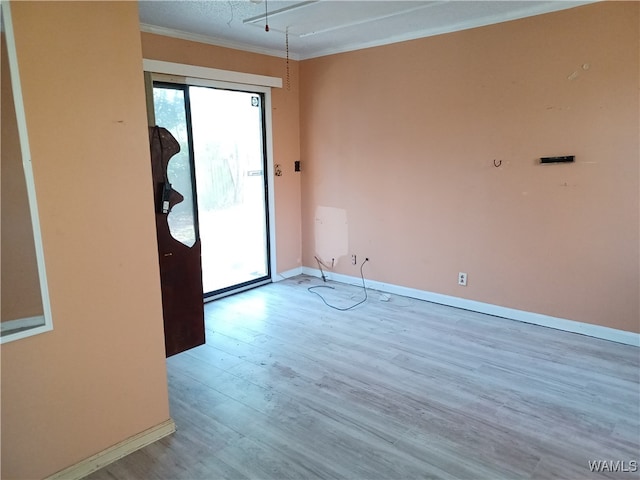 unfurnished room with hardwood / wood-style flooring and ornamental molding