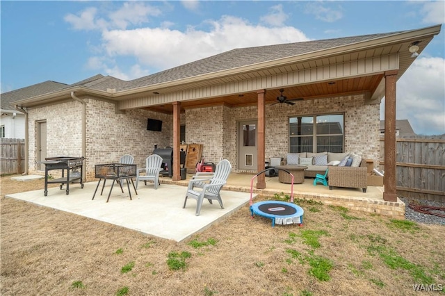 back of house with a patio area, an outdoor living space with a fire pit, and ceiling fan