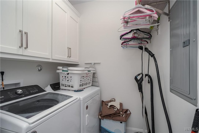 clothes washing area featuring washing machine and dryer and cabinets