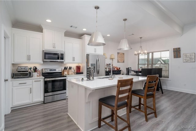 kitchen featuring stainless steel appliances, an island with sink, and white cabinets