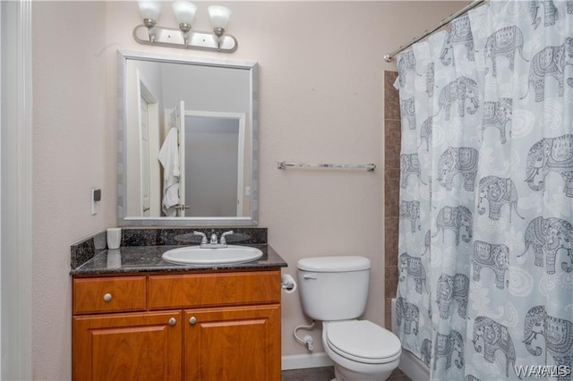 bathroom with vanity, curtained shower, and toilet