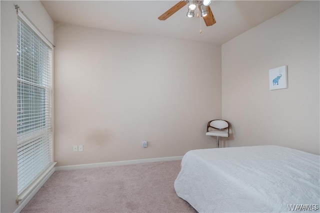 bedroom featuring light colored carpet and ceiling fan