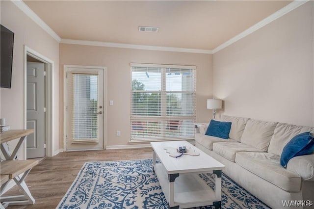 living room with crown molding and light wood-type flooring