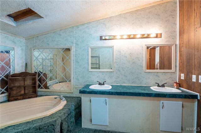 bathroom with vanity, a bathtub, crown molding, and a textured ceiling