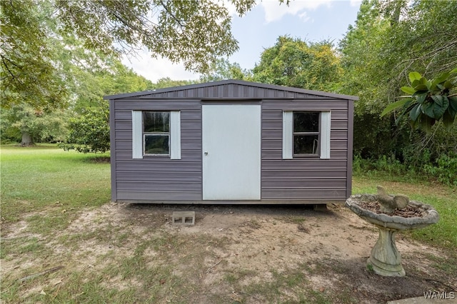 view of outbuilding featuring a yard