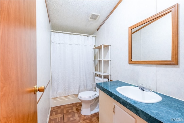 bathroom featuring parquet flooring, crown molding, a textured ceiling, toilet, and vanity