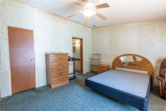 carpeted bedroom featuring ceiling fan and a textured ceiling