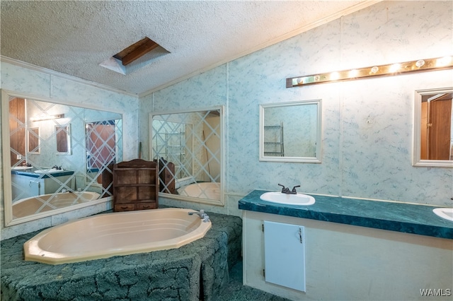 bathroom with vanity, lofted ceiling, ornamental molding, a textured ceiling, and tiled tub