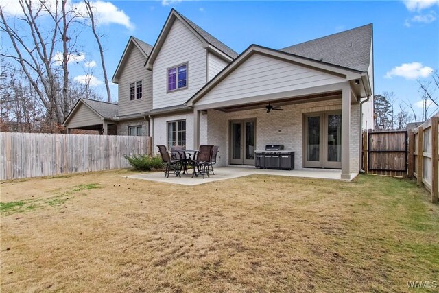 301 Trails End Ln, Tuscaloosa, AL 35406 - rear view of house with a ceiling fan, a fenced backyard, a yard, a patio, and brick siding
