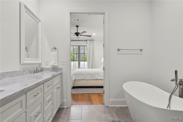 301 Trails End Ln, Tuscaloosa, AL 35406 - bathroom with tile patterned flooring, visible vents, vanity, a freestanding tub, and ceiling fan