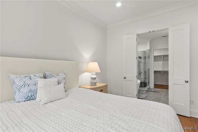 301 Trails End Ln, Tuscaloosa, AL 35406 - bedroom featuring a walk in closet, wood finished floors, and ornamental molding