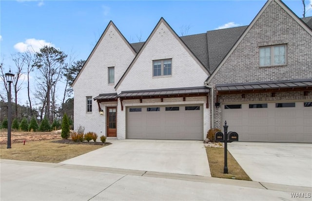 301 Trails End Ln, Tuscaloosa, AL 35406 - multi unit property featuring a garage, a standing seam roof, brick siding, and concrete driveway