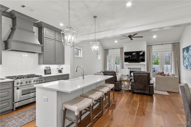 301 Trails End Ln, Tuscaloosa, AL 35406 - kitchen featuring high end range, visible vents, custom exhaust hood, and gray cabinetry