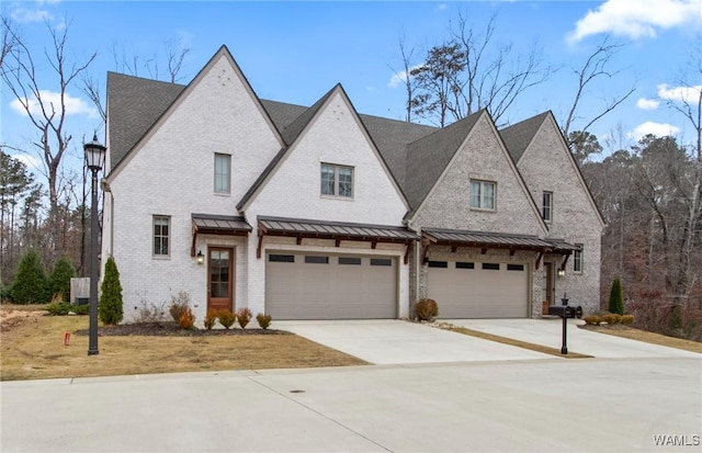 301 Trails End Ln, Tuscaloosa, AL 35406 - view of front of home featuring brick siding, an attached garage, a standing seam roof, and concrete driveway