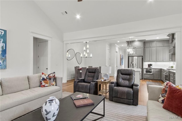 301 Trails End Ln, Tuscaloosa, AL 35406 - living area featuring a chandelier, light wood-style flooring, lofted ceiling, and recessed lighting