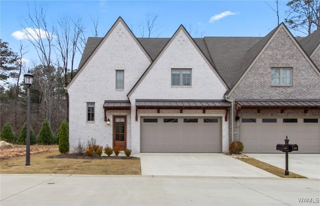 301 Trails End Ln, Tuscaloosa, AL 35406 - view of front of home featuring an attached garage, driveway, brick siding, and roof with shingles