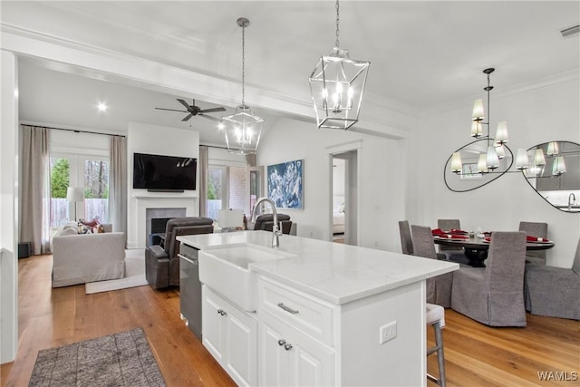 301 Trails End Ln, Tuscaloosa, AL 35406 - kitchen with light wood-style flooring, a tile fireplace, open floor plan, and a sink